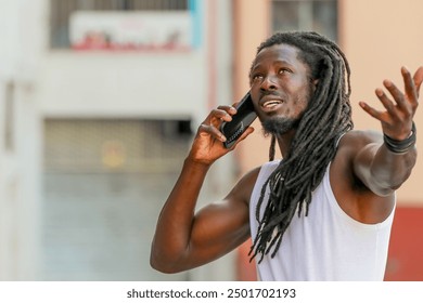 young man with afro hair or dreadlocks talking on mobile phone on the street - Powered by Shutterstock