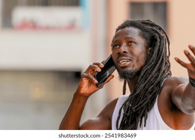 young man with afro hair or dreadlocks talking on mobile phone on the street - Powered by Shutterstock