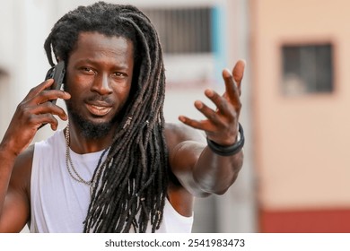 young man with afro hair or dreadlocks talking on mobile phone on the street - Powered by Shutterstock