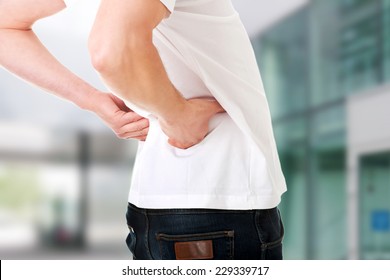 Young Man In Agony With Back Pain