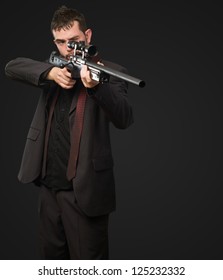 Young Man Aiming With Rifle against a black background