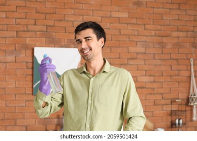 Young Man With Air Freshener At Home