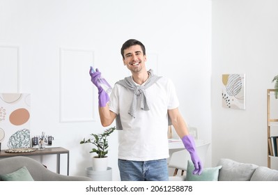 Young Man With Air Freshener At Home