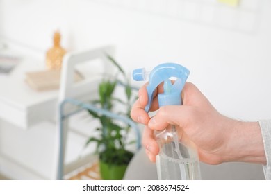 Young Man With Air Freshener At Home, Closeup