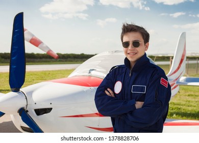 Young Man Aircraft Pilot Standing Front Of Light Aircraft