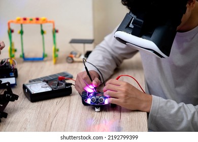 Young man  amateur inventor testing electronic device model inventions  wear vr glasses to show high technology - Shutterstock ID 2192799399
