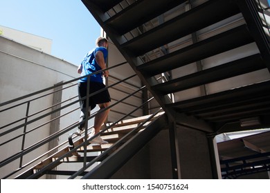 young man and amputee athlete, testing his new prosthesis by climbing stairs - Powered by Shutterstock