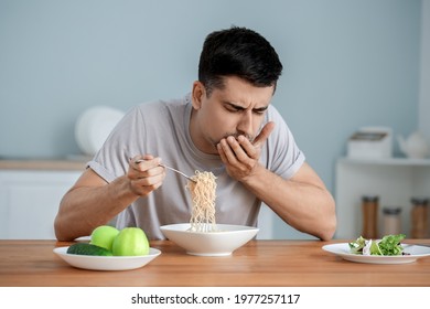 Young Man With Anorexia Eating Noodles At Home