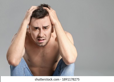 Young Man With Anorexia On Grey Background