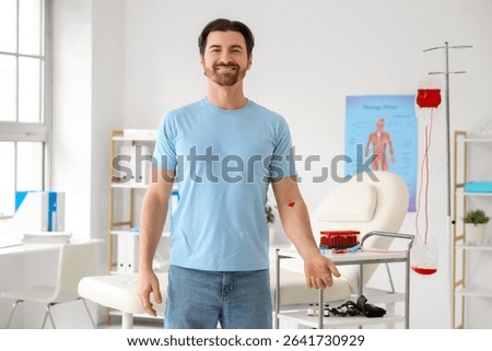 Young man with applied patch after donating blood in clinic