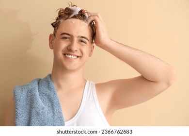 Young man with applied shampoo on his hair against beige background - Shutterstock ID 2366762683