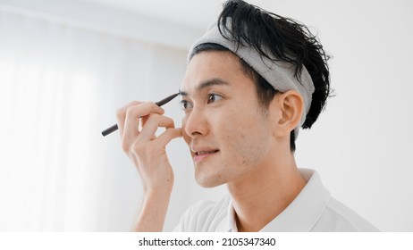 Young Man Applying Eyebrow Makeup Beauty Image