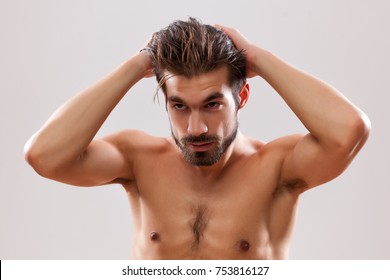 Young Man Is Applying Hair Gel To His Hair.