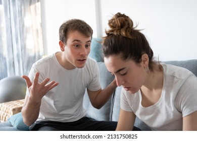 Young man arguing with sad girlfriend