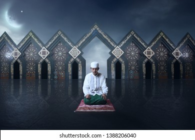 Young Man Asian Moslem Pray On The Night With Mosque And Moon Background