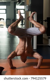 Young Man Athlete Doing Extreme Pushups Handstand As Part Of Bodybuilding Training