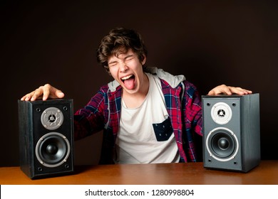 Young Man Audiophile Listen To Loud Music From Speakers