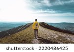 Young man with backpack hiking mountains - Hiker having trekking day out on a sunny day - Successful, sport and inspirational concept