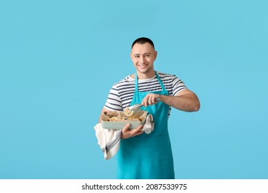 Young Man With Baking Dish On Color Background