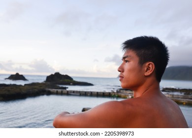 Young Man Bare-chested Man  Sitting On The Beach Barefoot. Scenic Ocean View, Morning Photo,