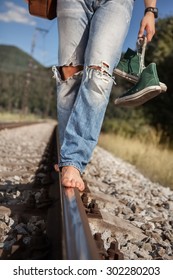 Young Man Barefoot  Legs In Ripped Jeans Close Up Image