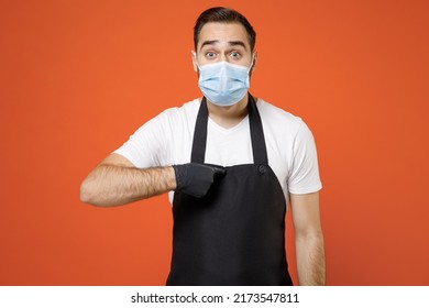 Young Man Barista Barman Employee In Apron White T-shirt Face Mask Coronavirus Covid19 Pandemic Quarantine Work Coffee Shop Point Index Finger On Himself Isolated On Orange Background Business Startup