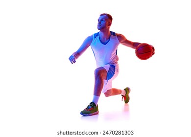 Young man, basketball player playing game, preparing for maneuver or shot in neon light against white studio background. Concept of professional sport, games, healthy lifestyle, tournament, action. Ad - Powered by Shutterstock