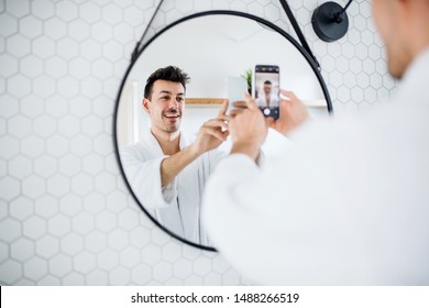 Young Man In The Bathroom In The Morning, Taking Selfie.