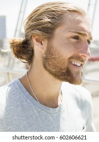 A Young Man With Beard, Red Hair And Ponytail