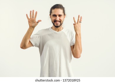 Young Man With A Beard Shows With His Fingers The Number Eight, Holding His Hands Up Sign 8.