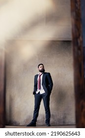 A Young Man With A Beard In A Suit In The Mirror