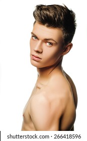 A young man with a beautiful physique. shirtless male model on white background