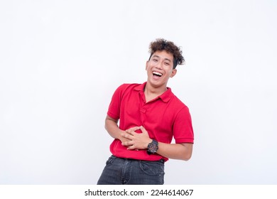 A young man bellyaching from laughter. A asian person having fun. Lighthearted scene isolated on a white background. - Shutterstock ID 2244614067