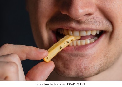 Young Man Bites Fries. Extreme Close Up. Guy Eats Eating Fried Potatoes, Isolated. Male Mouth.