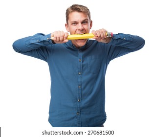 Young Man Biting A Big Pencil