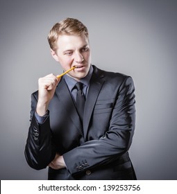 Young Man Biting A Pencil