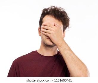 Young Man Blocking Face With Hands