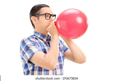 Young man blowing up a balloon isolated on white background