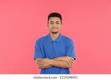 Young Man In Blue Polo On Pink Background