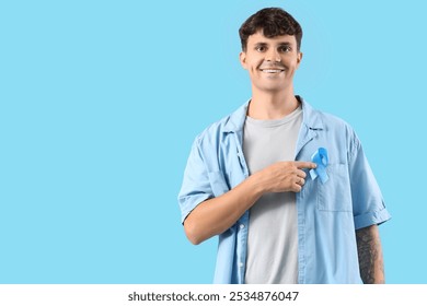 Young man with blue ribbon on color background. Prostate cancer awareness concept - Powered by Shutterstock