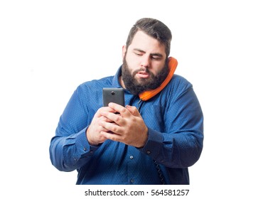 Young man with blue shirt has a retro orange phone with his head and in his hand hold a smartphone isolated on white background