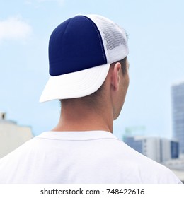 Young Man In A Blue And White Trucker Hat, And White T-shirt. Blue Baseball Cap Mockup. Close-up