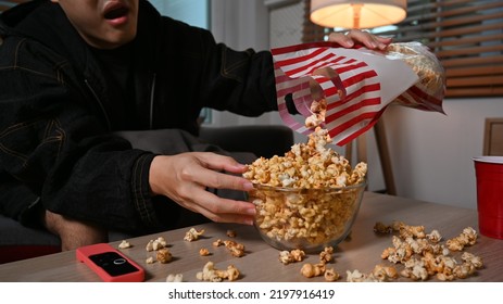 Young Man With Bowl Of Popcorn, Watching Movie At Night. Entertainment And Leisure Activity Concept