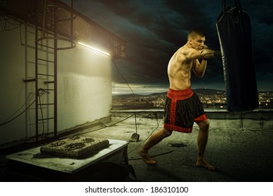 Young Man Boxing Training , On Top Of The House Above The City