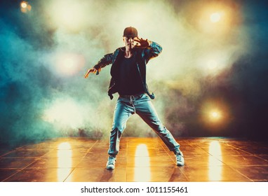 Young Man Break Dancing In Club With Lights And Smoke