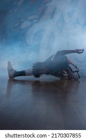 Young Man Break Dancing In Club With Lights And Smoke.