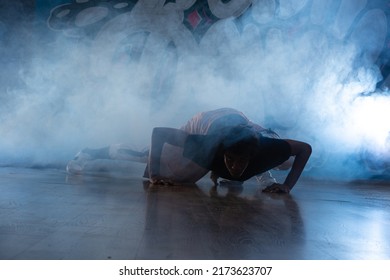 Young Man Break Dancing In Club With Lights And Smoke.