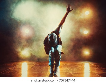 Young man break dancing in club with lights and smoke. Tattoo on body. - Powered by Shutterstock