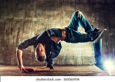 Young Man Break Dancing On Old Wall Background