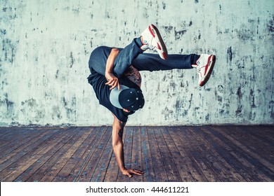 Young man break dancing on wall background - Shutterstock ID 444611221